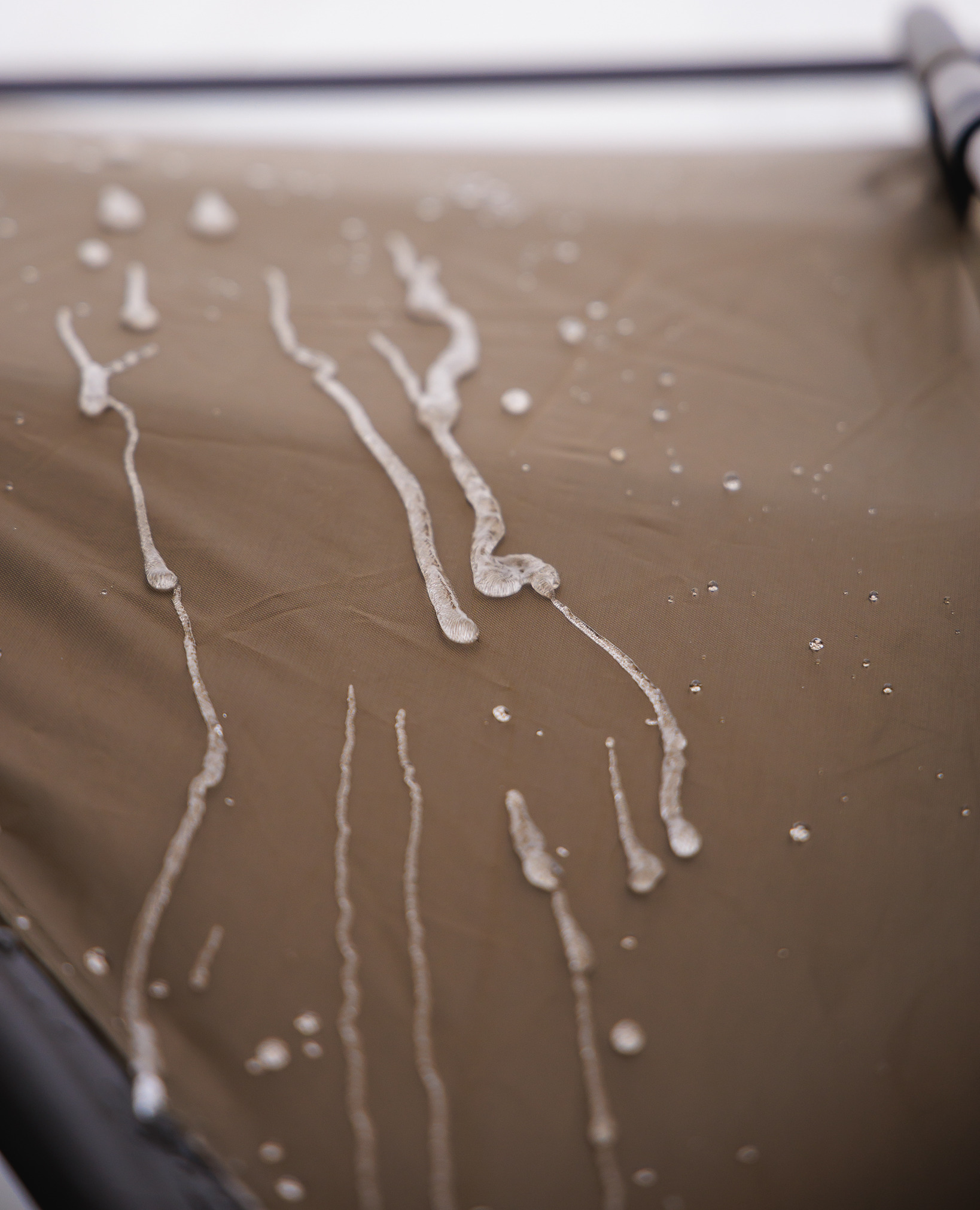frost, drip marks, white residue, wet surface, brown canvas